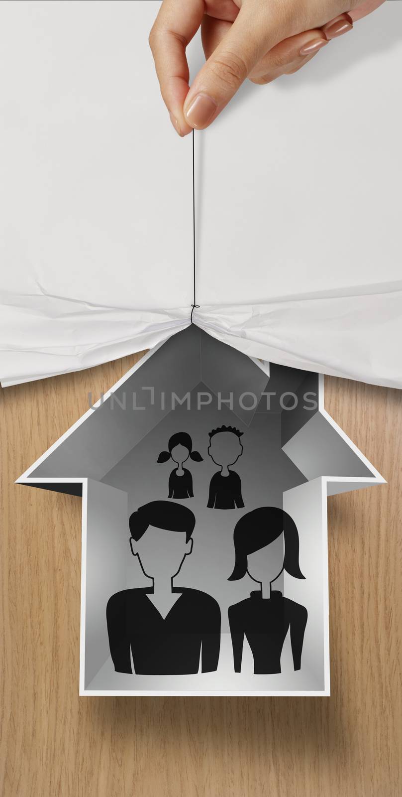 hand open crumpled paper to show hand draw family and house icon on wooden poster as insurance concept