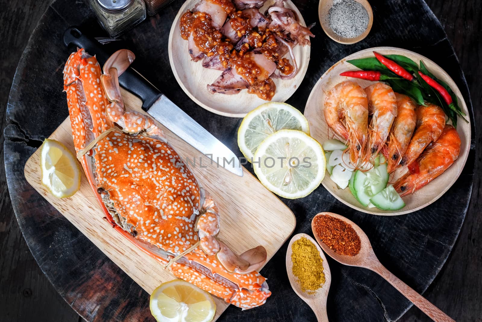 Sqide,jumbo crab and shrimp on dark background by Surasak