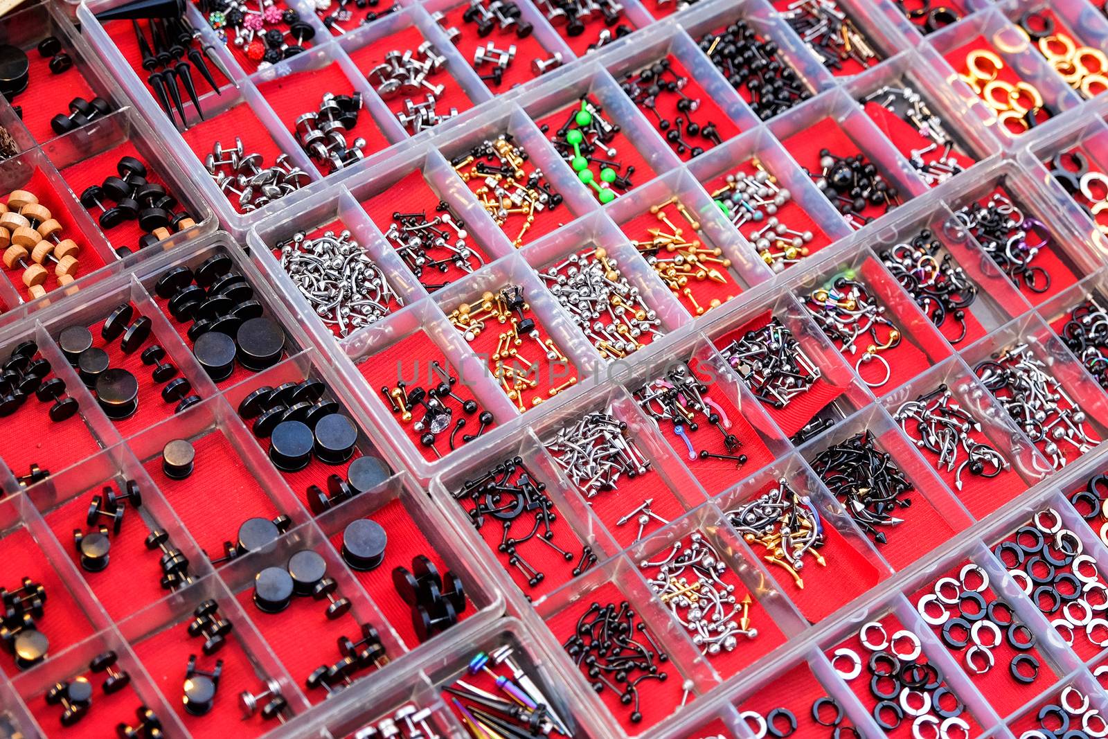 Earrings on the stall in street night market by Surasak