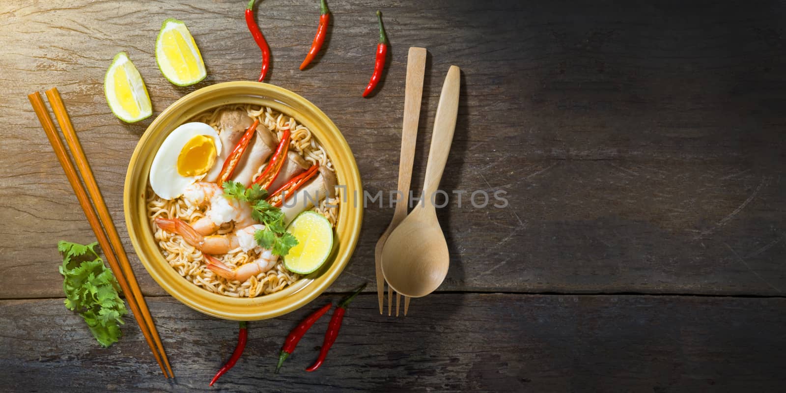Thai food style noodle, tom yum kung on wood background and space for text
