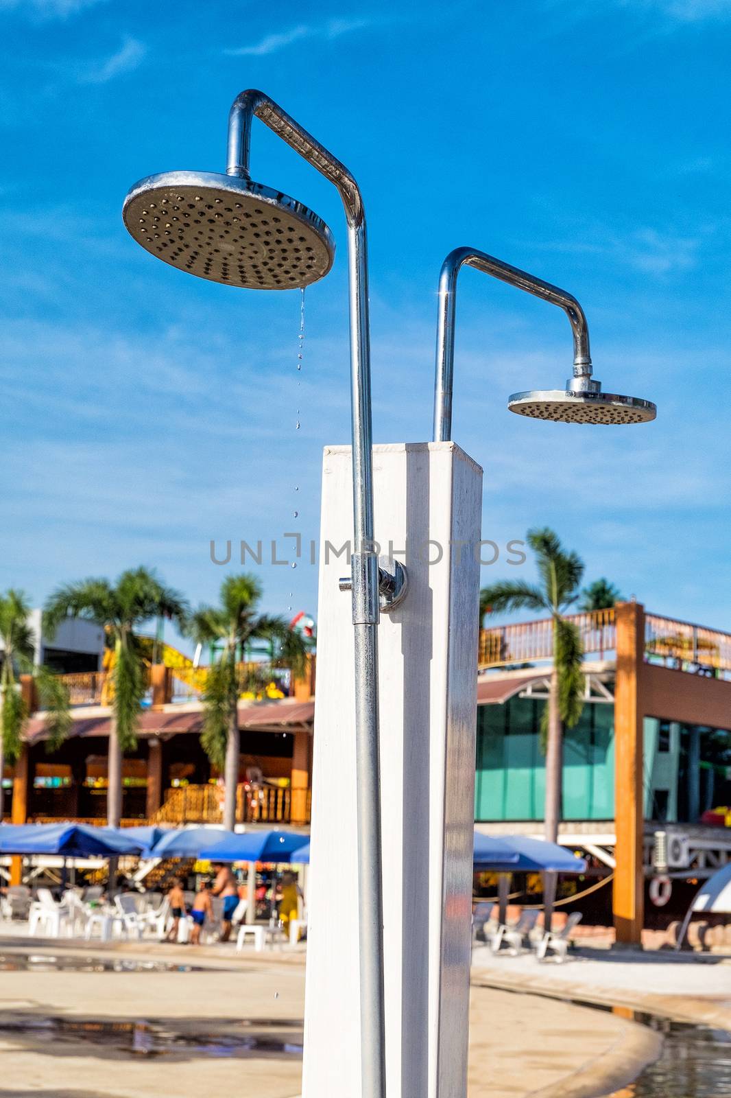 Close-up of shower head with flowing water in Waterpark by Surasak