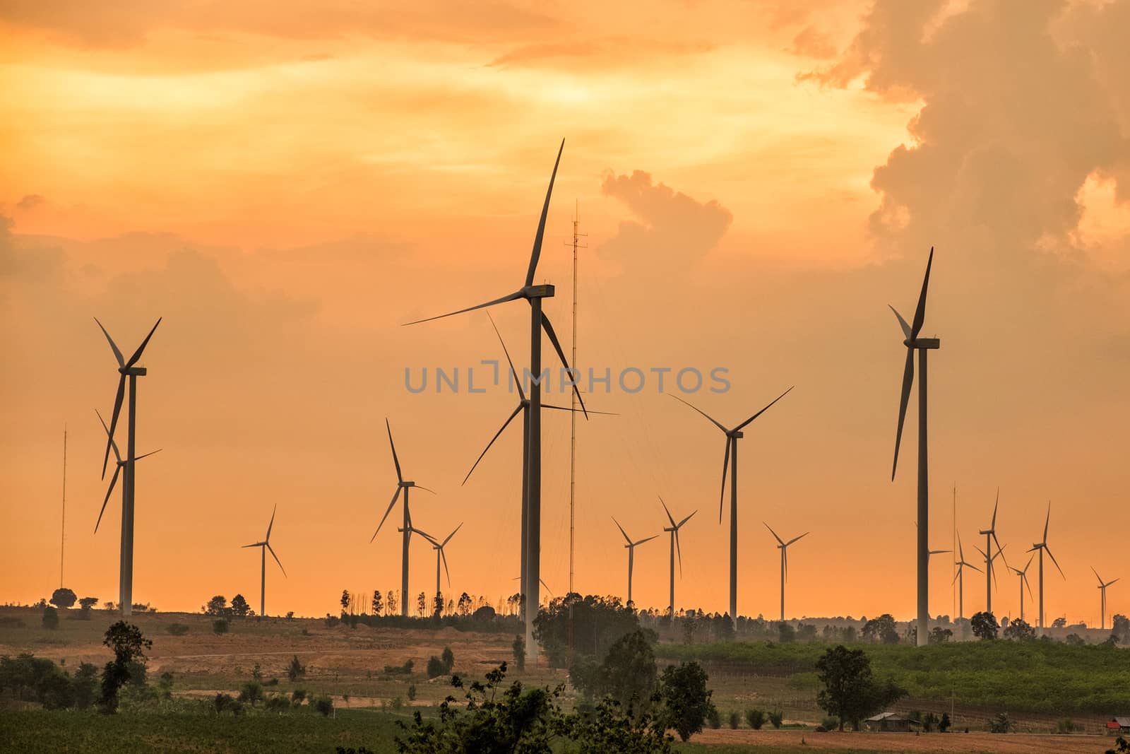 Wind turbine power at sunset by Surasak