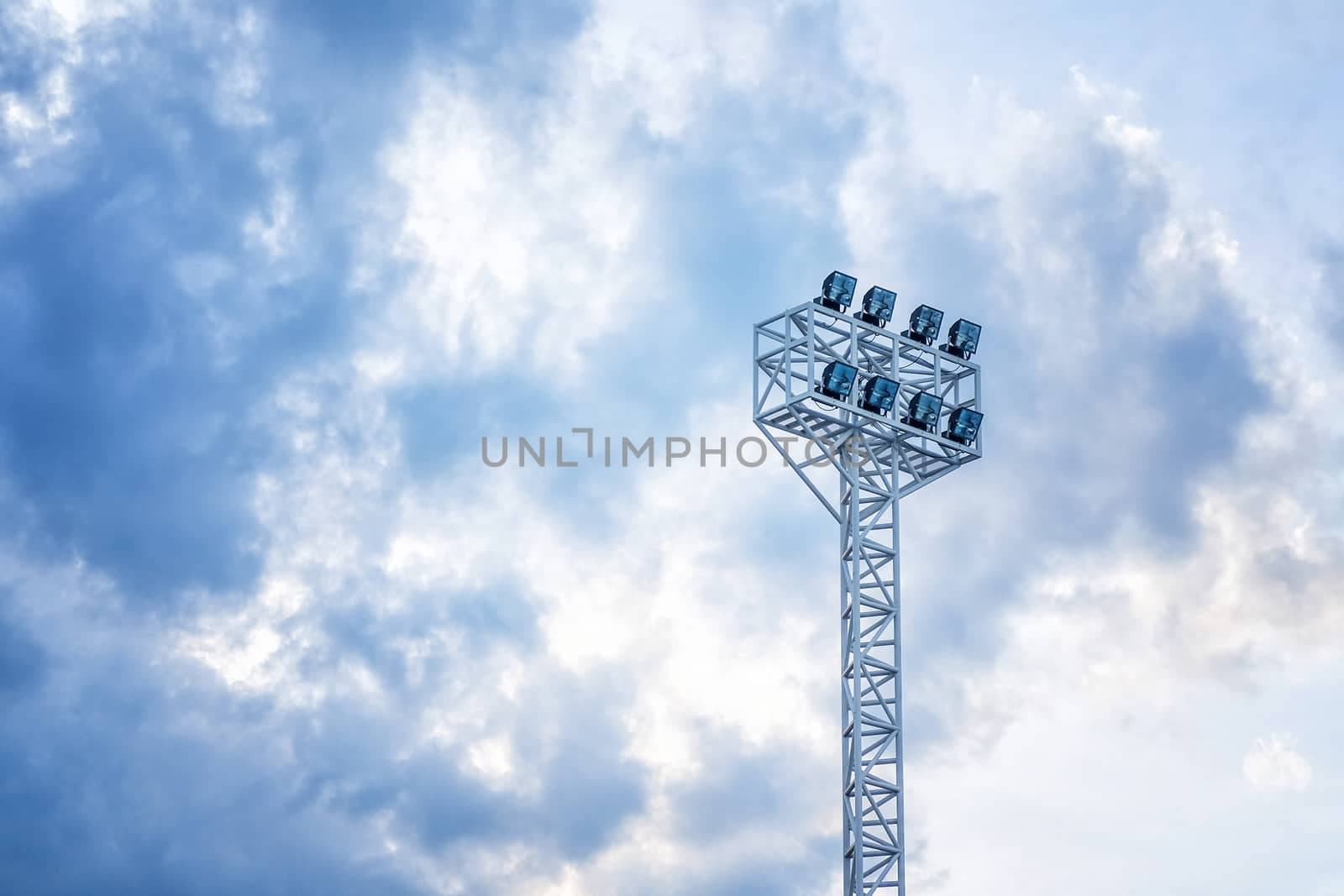 Stadium lights in daylight and blue sky background