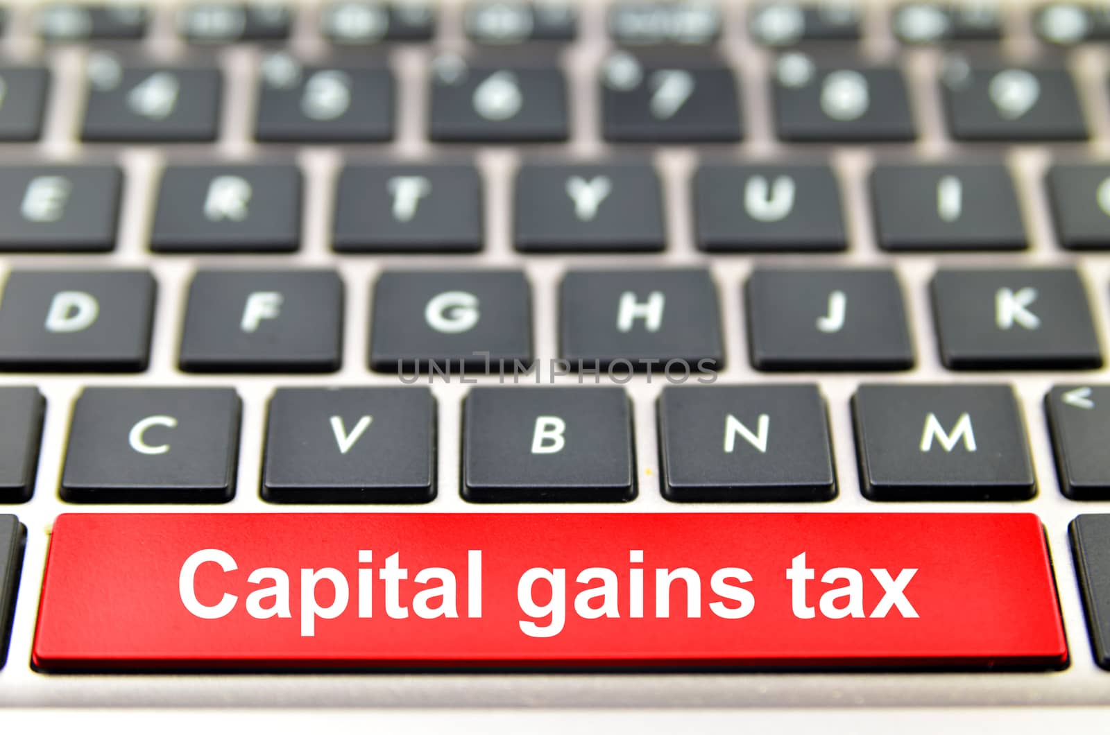 Capital gains tax word on computer space bar by tang90246