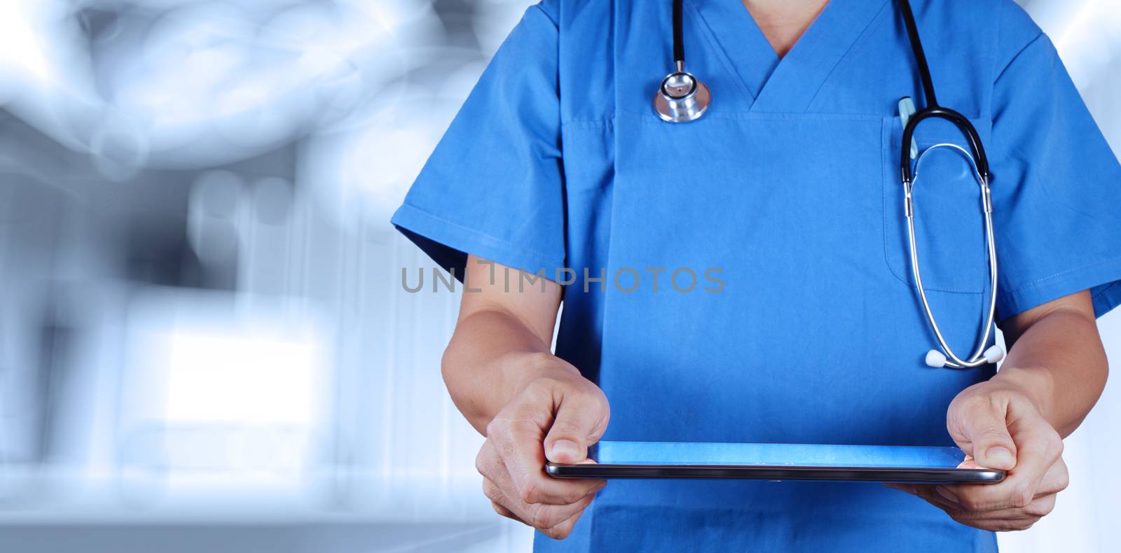 Doctor working with tablet computer with operating room by everythingpossible