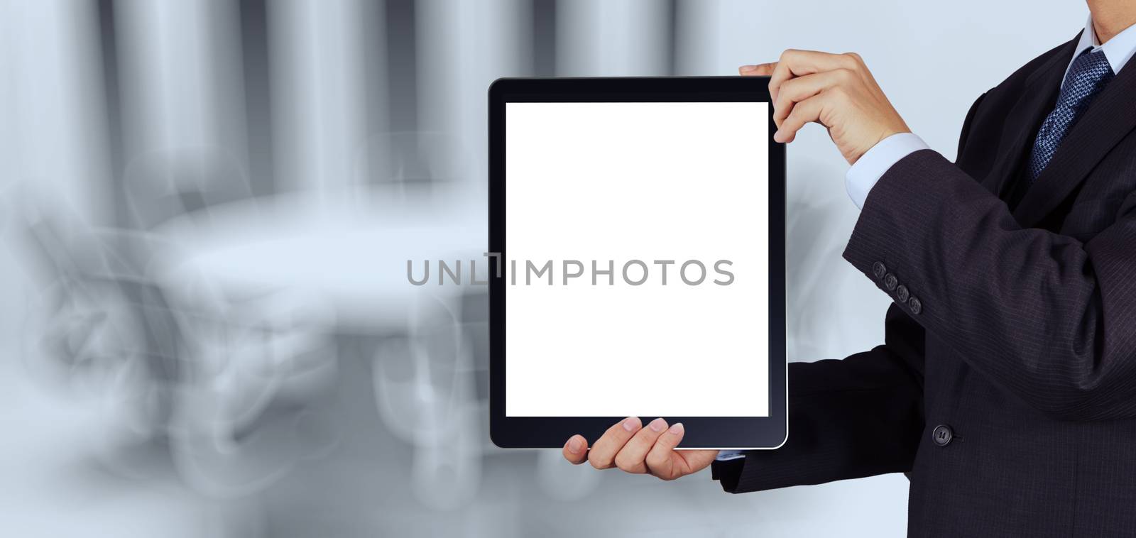 businessman success working with blank tablet computer his board room background as concept 