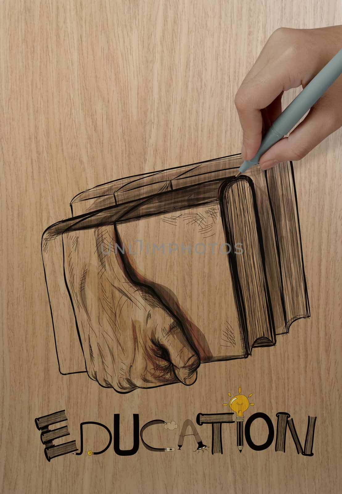 hand drawing hands holding the books on wood background as creative concept 