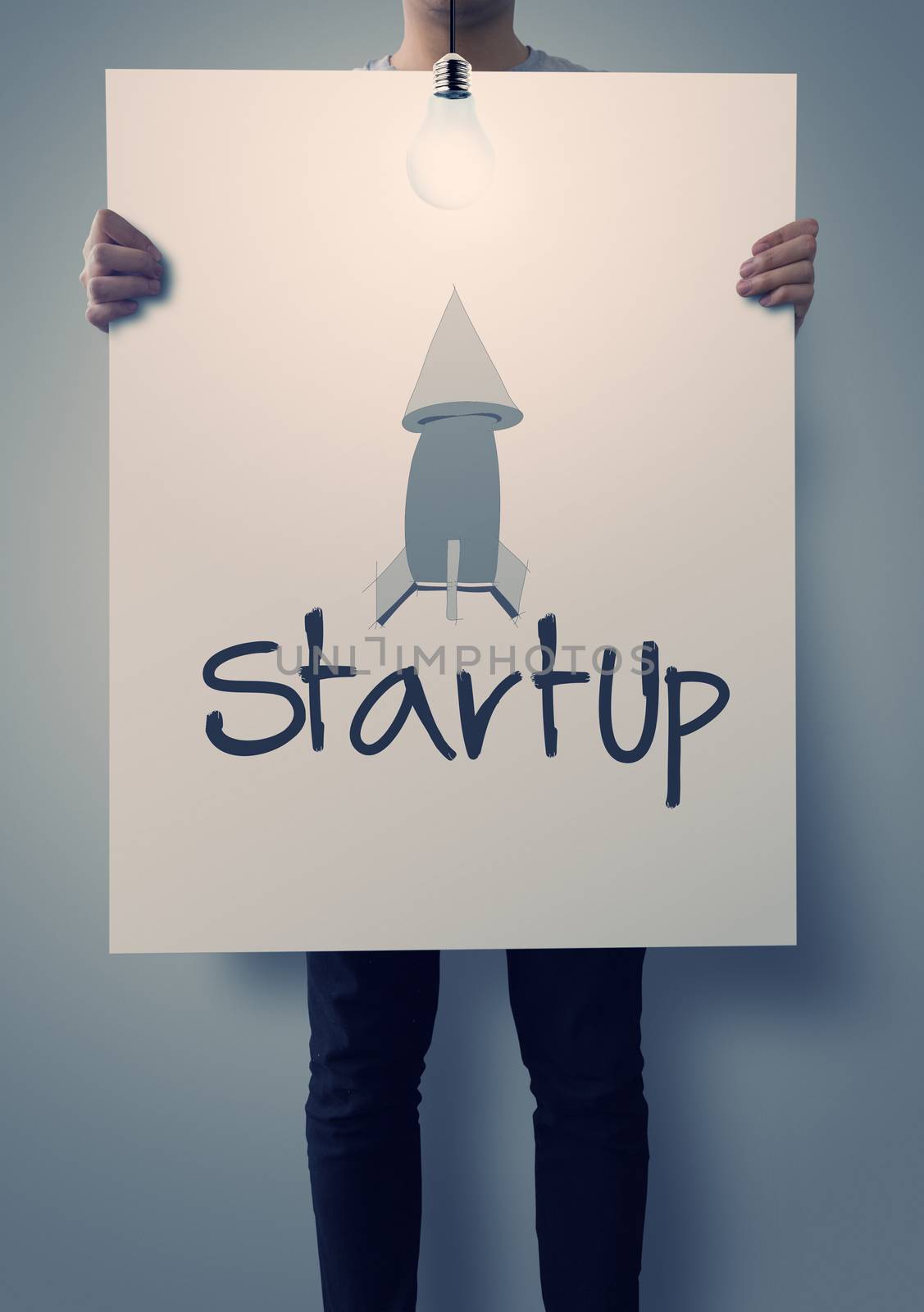 businessman hand showing poster of start up icon as concept 