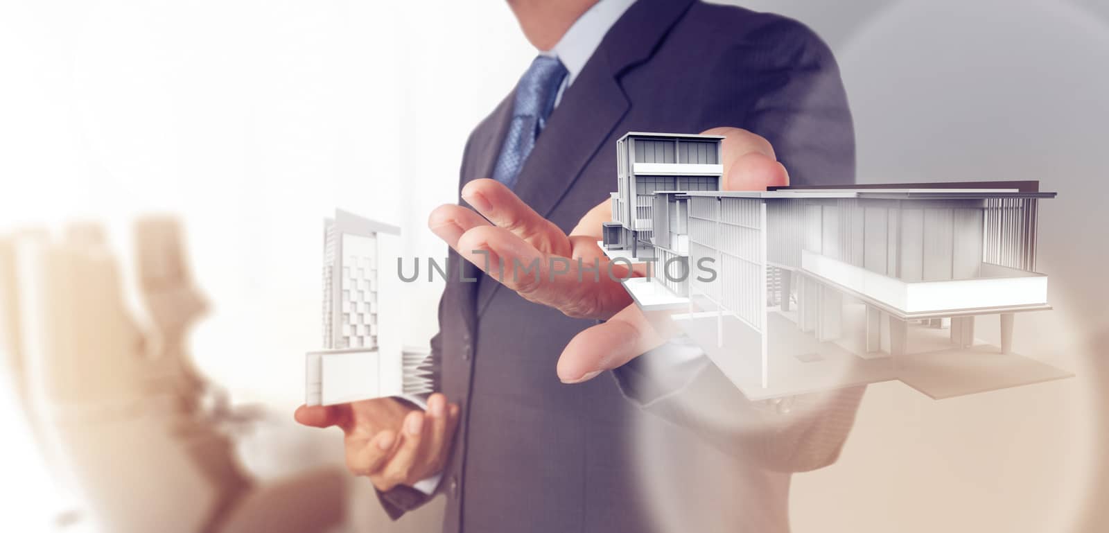 businessman hand presents house model on modern computer by everythingpossible