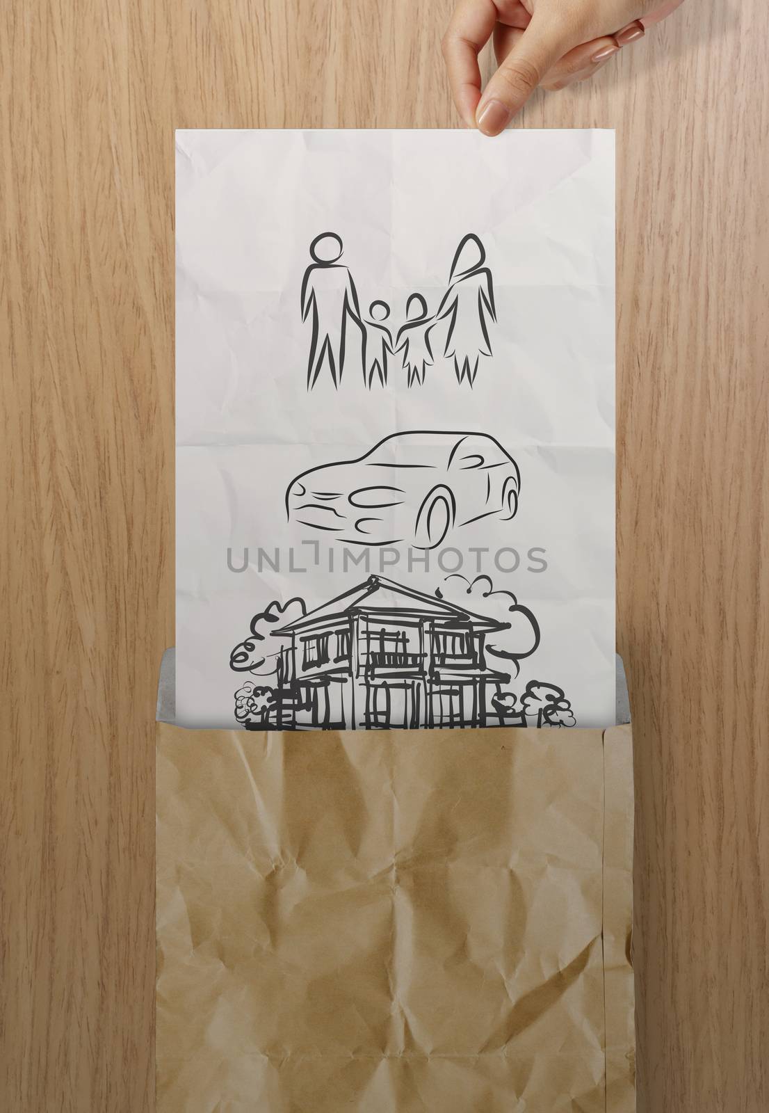 hand open crumpled paper to show planning family future on wood  by everythingpossible