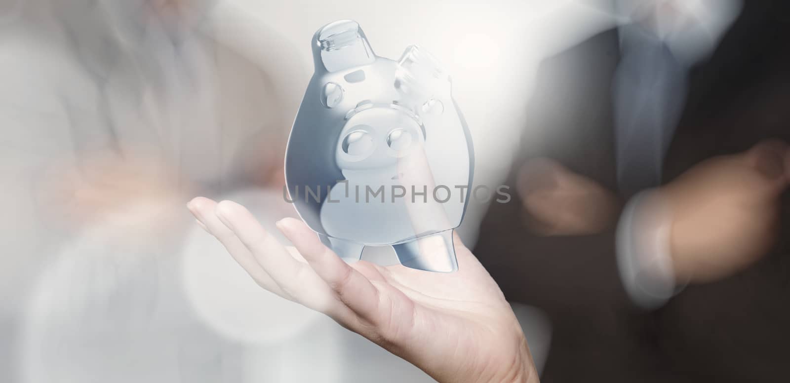 businessman hand shows piggy bank as concept  by everythingpossible