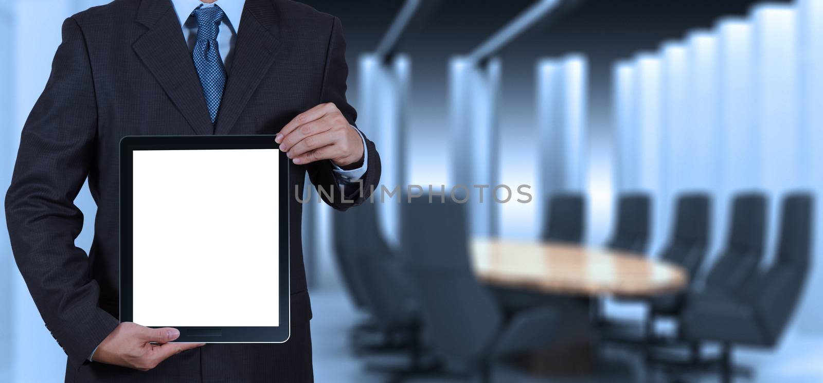 businessman success working with blank tablet computer his board room background as concept