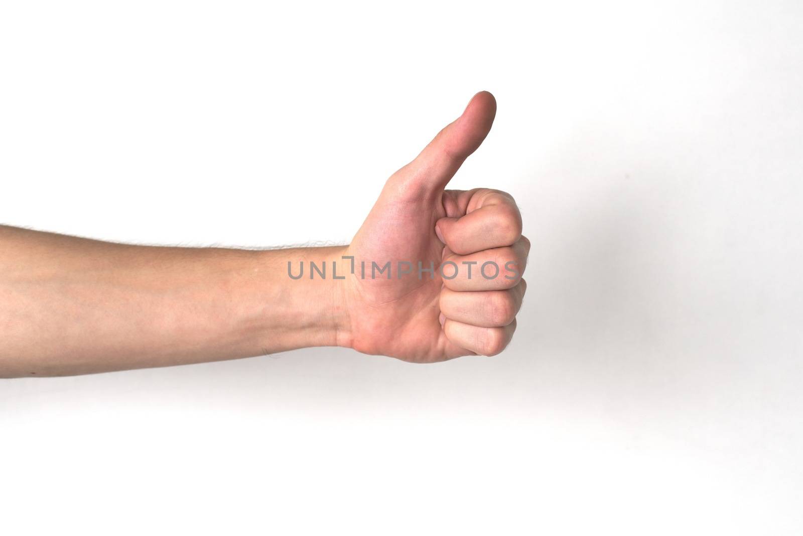 White ethnicity hand doing a "thumb up" against a white background. Positivity, approval, success concept.