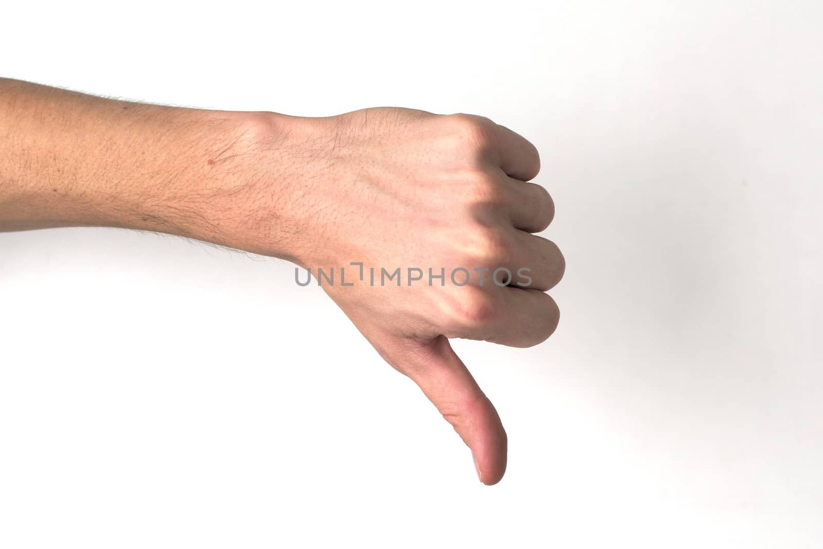 White hand doing a "thumb down" against a white background. Negativity, rejection, disapproval concept.