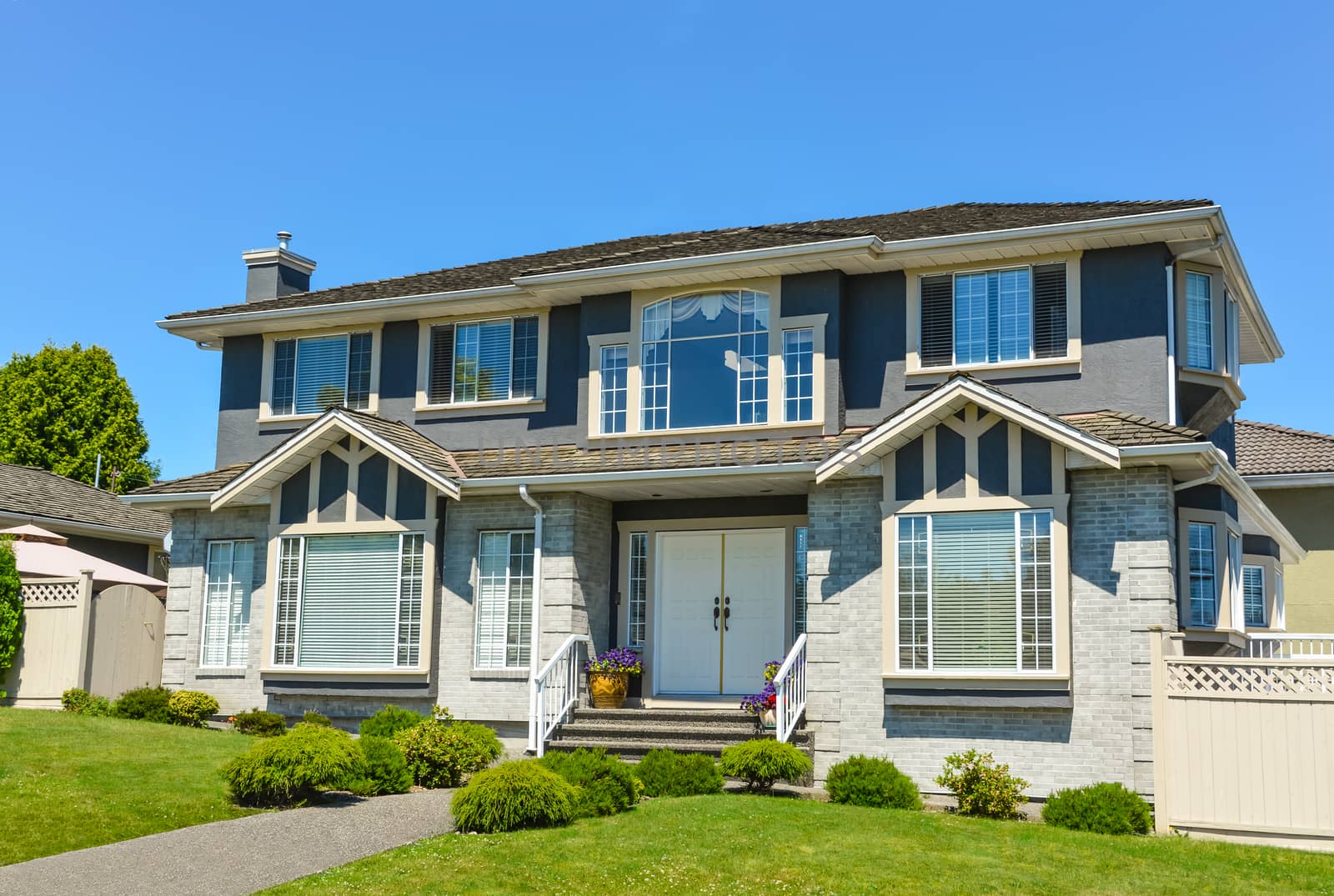 Big family house in suburbs of Vancouver on blue sky background