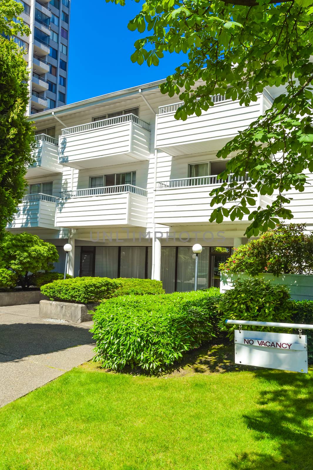 Low-rise apartment building in suburb of Vancouver, Canada. Apartment building on a sunny day with blue sky background