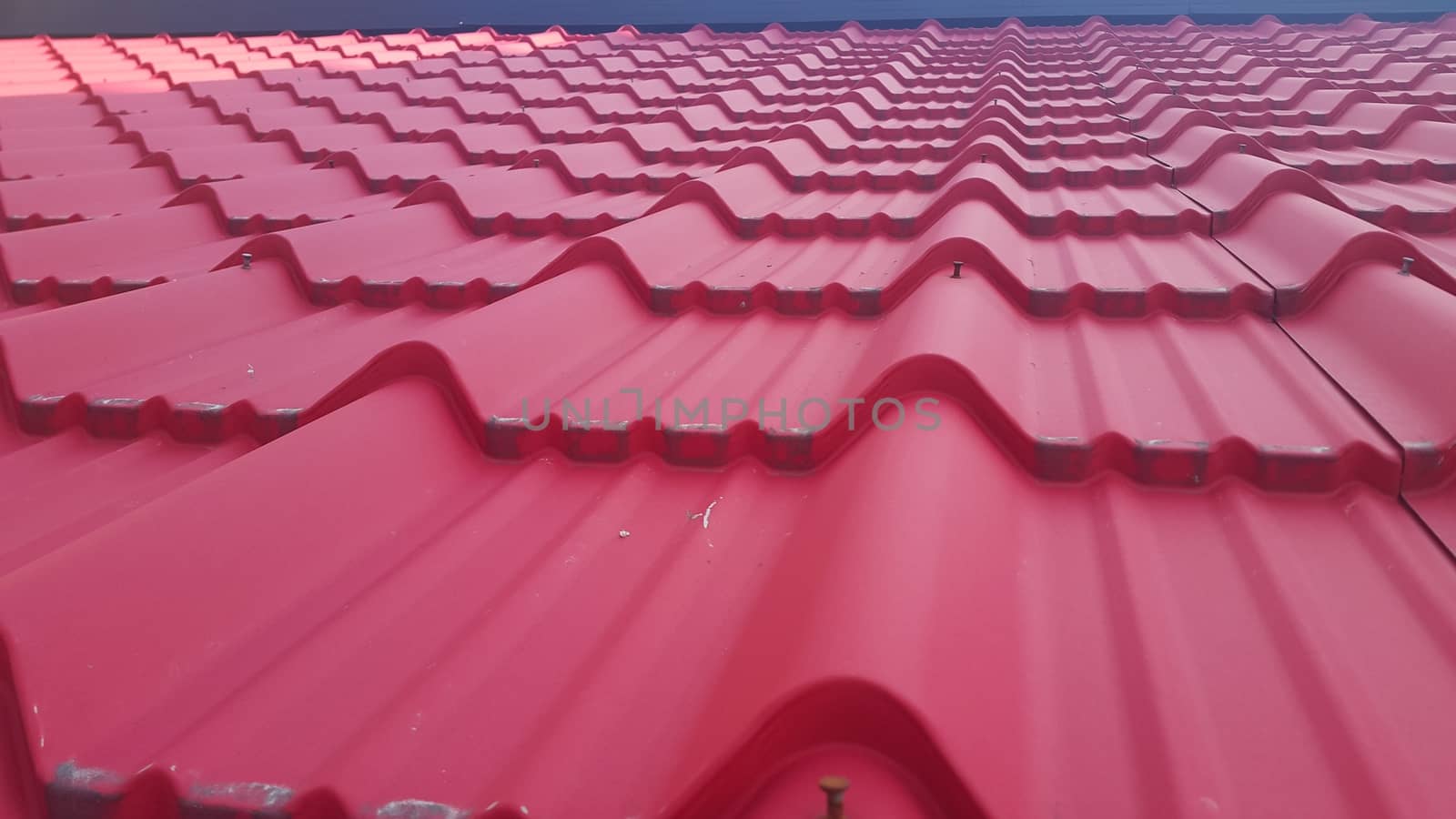 Closeup of red color roof tiles. Background texture for rooftop tiles.