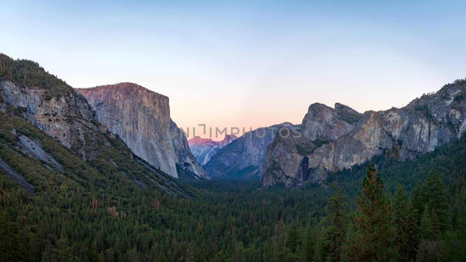 Yosemite valley nation park during sunset view from tunnel view on twilight time. Yosemite nation park, California, USA. Panoramic image.