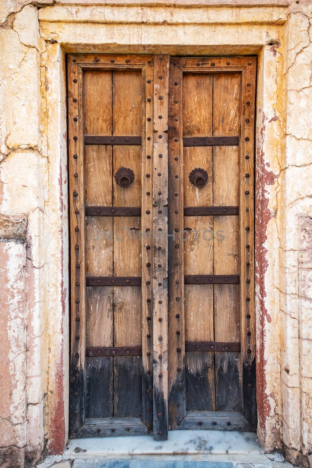 Antique rustic ancient wooden door. Architectural element.