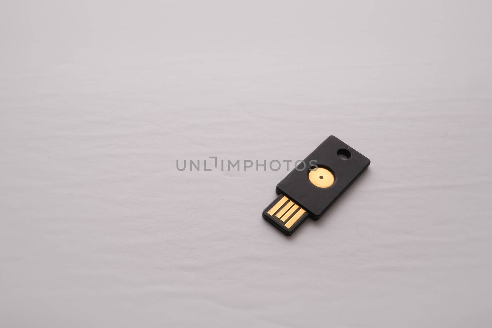 An isolated USB device containing a security key is used for two-factor authentication adding a layer of security to logins and authorization online.
