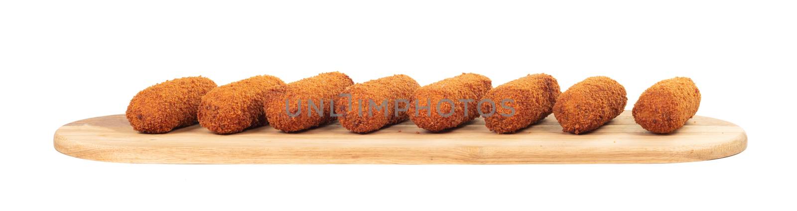 Brown crusty dutch kroketten on a serving tray, isolated on a white background