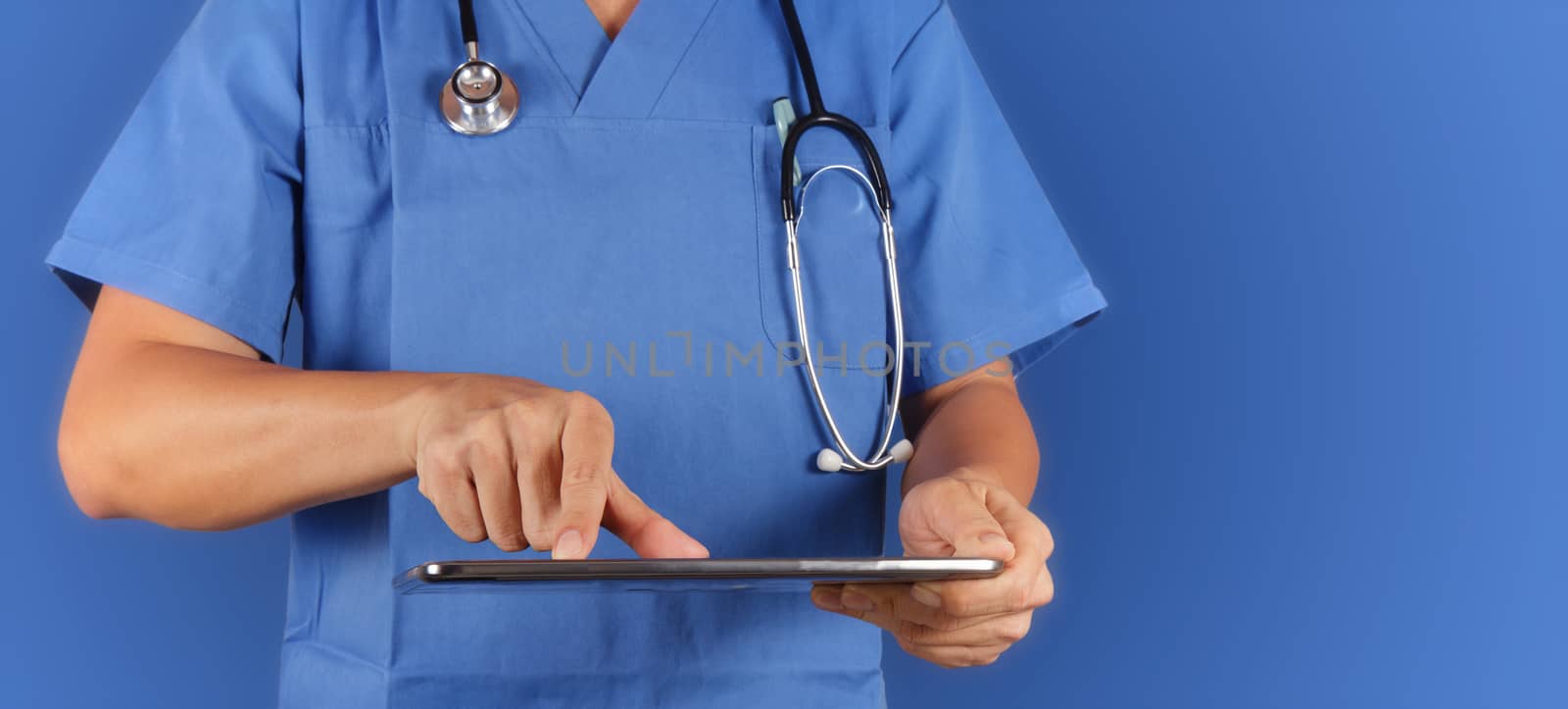 Doctor working with tablet computeron blue  background 
