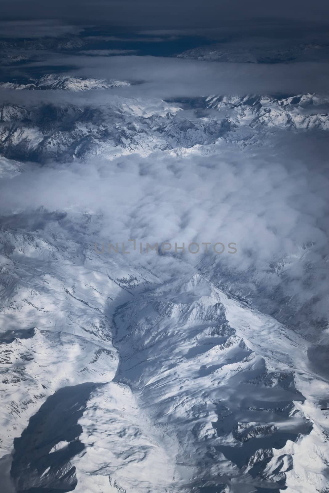 Snowy mountains in the Italian alps. Aerial, high altitude view. by hernan_hyper