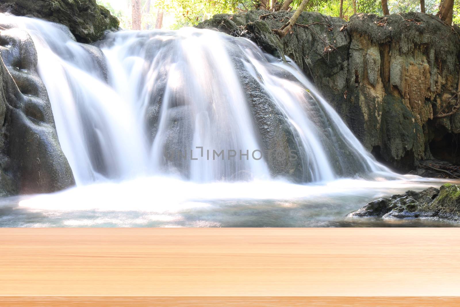 wood plank on waterfall beautiful nature background, empty wood table floors on nature waterfall fresh in forest, wood table board empty on garden waterfall (wang kan luang waterfall) thailand