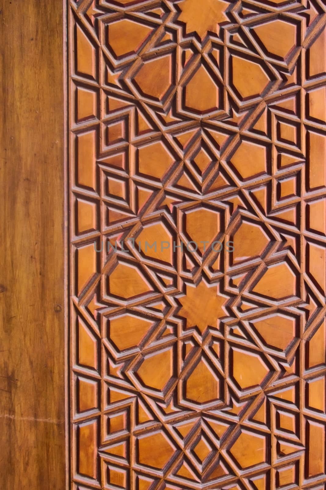 Geometrical pattern on a wooden door at a the Sehzade Mosque in Istanbul, Turkey. Islamic art, woodwork, detail close up. by hernan_hyper