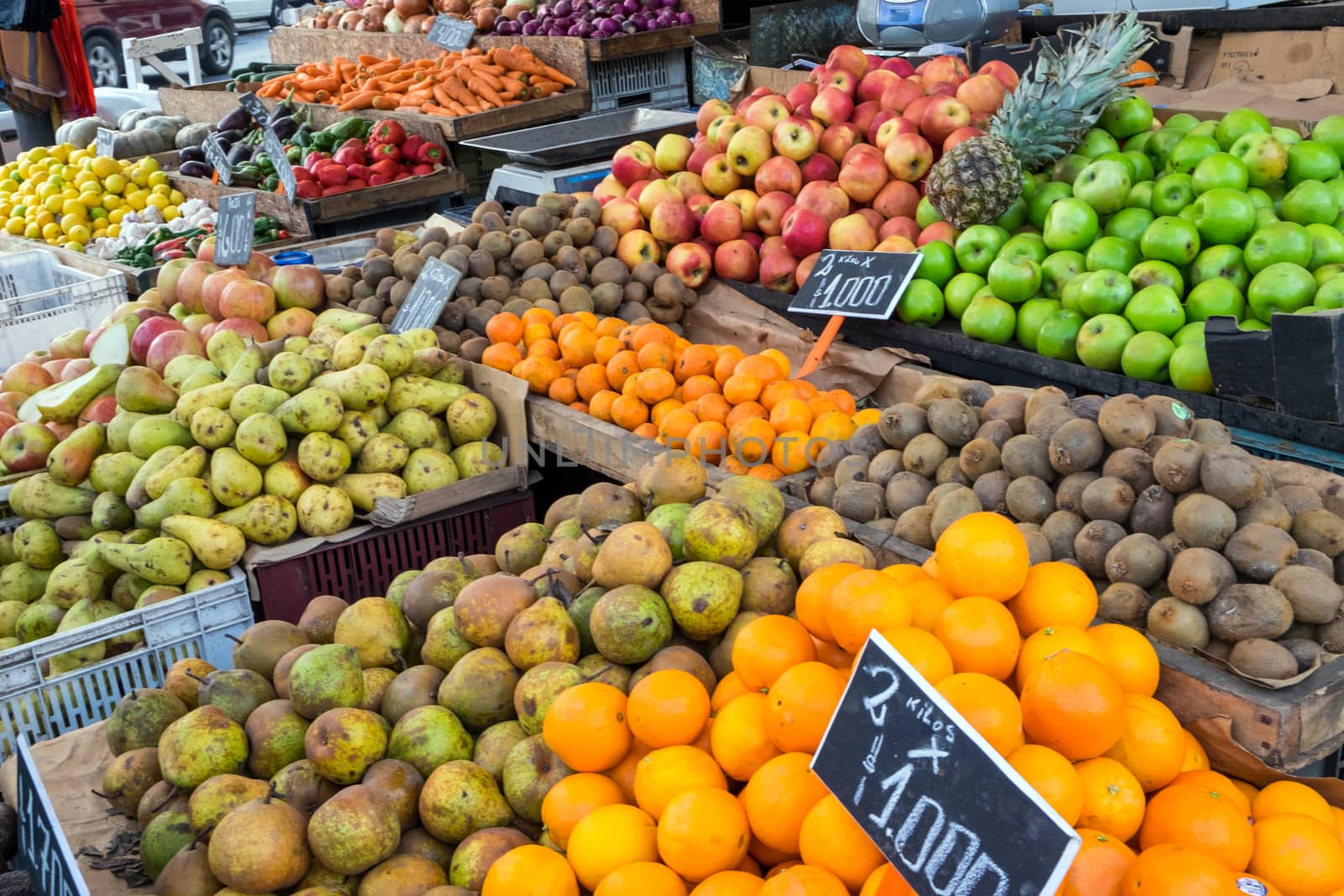 Piles of fruits for sale at a market by elxeneize