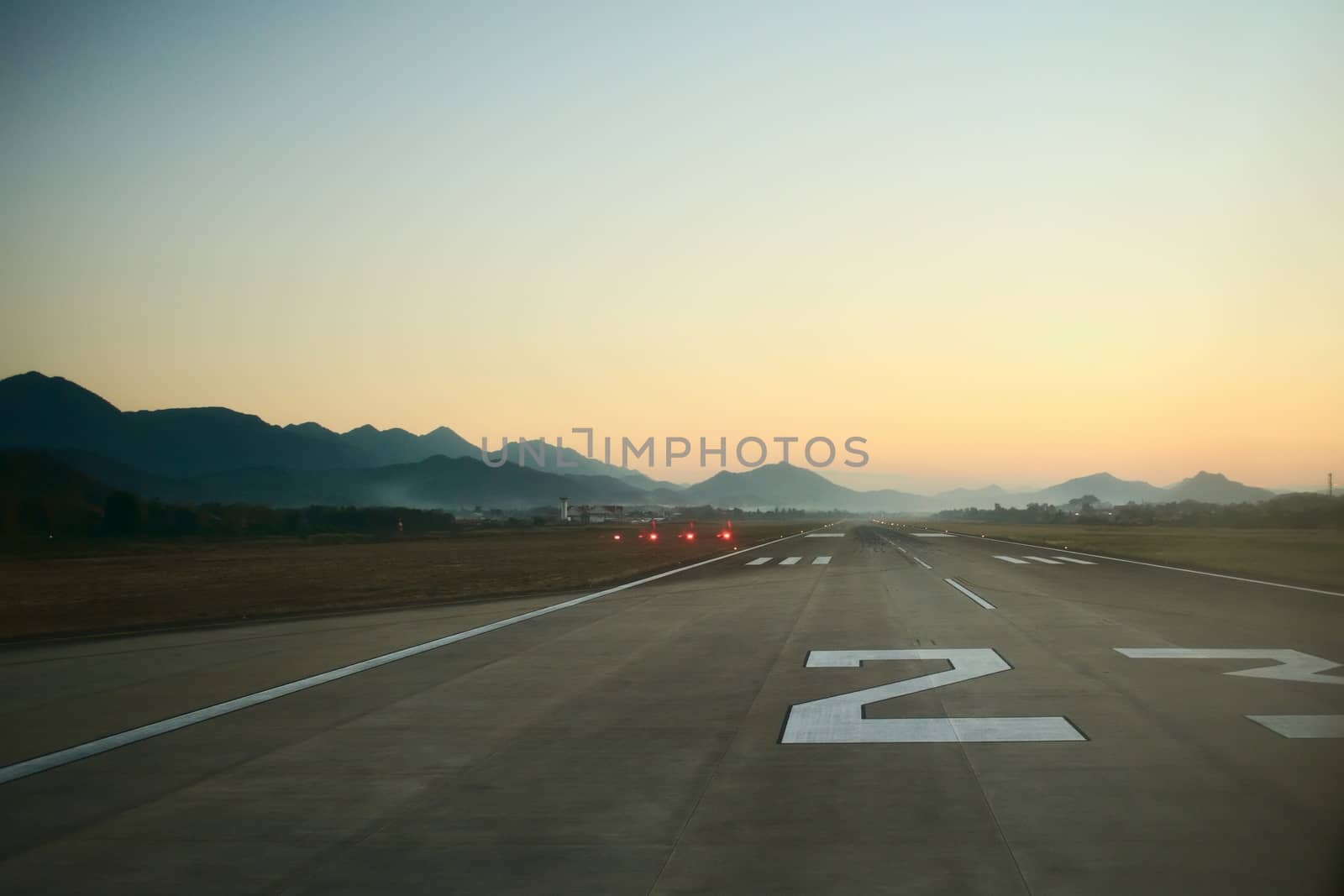 Airport runway at dawn. Travel, air transport, aeronautical industry concept. by hernan_hyper