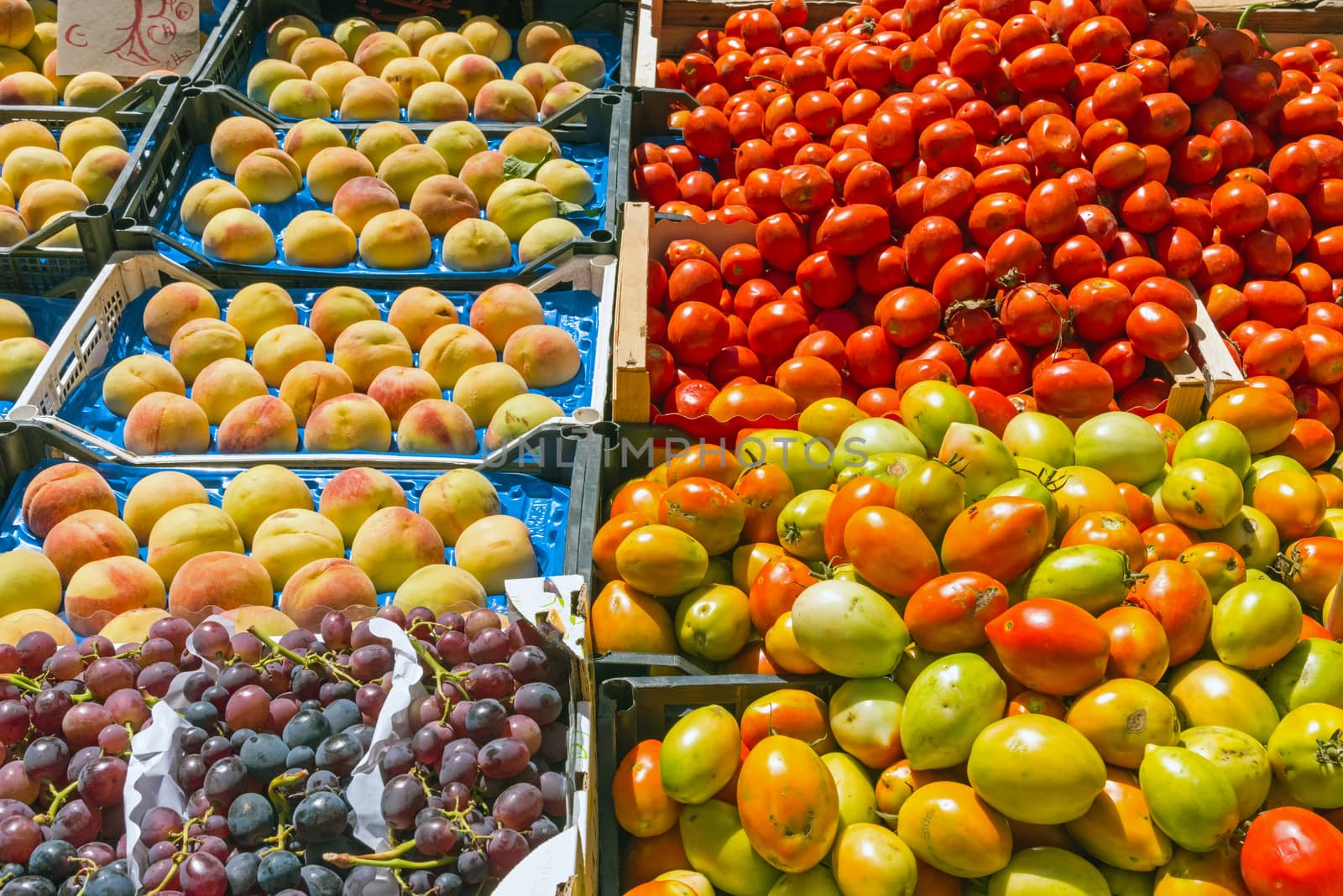 Tomatoes, grapes and peaches for sale at a market in Palermo