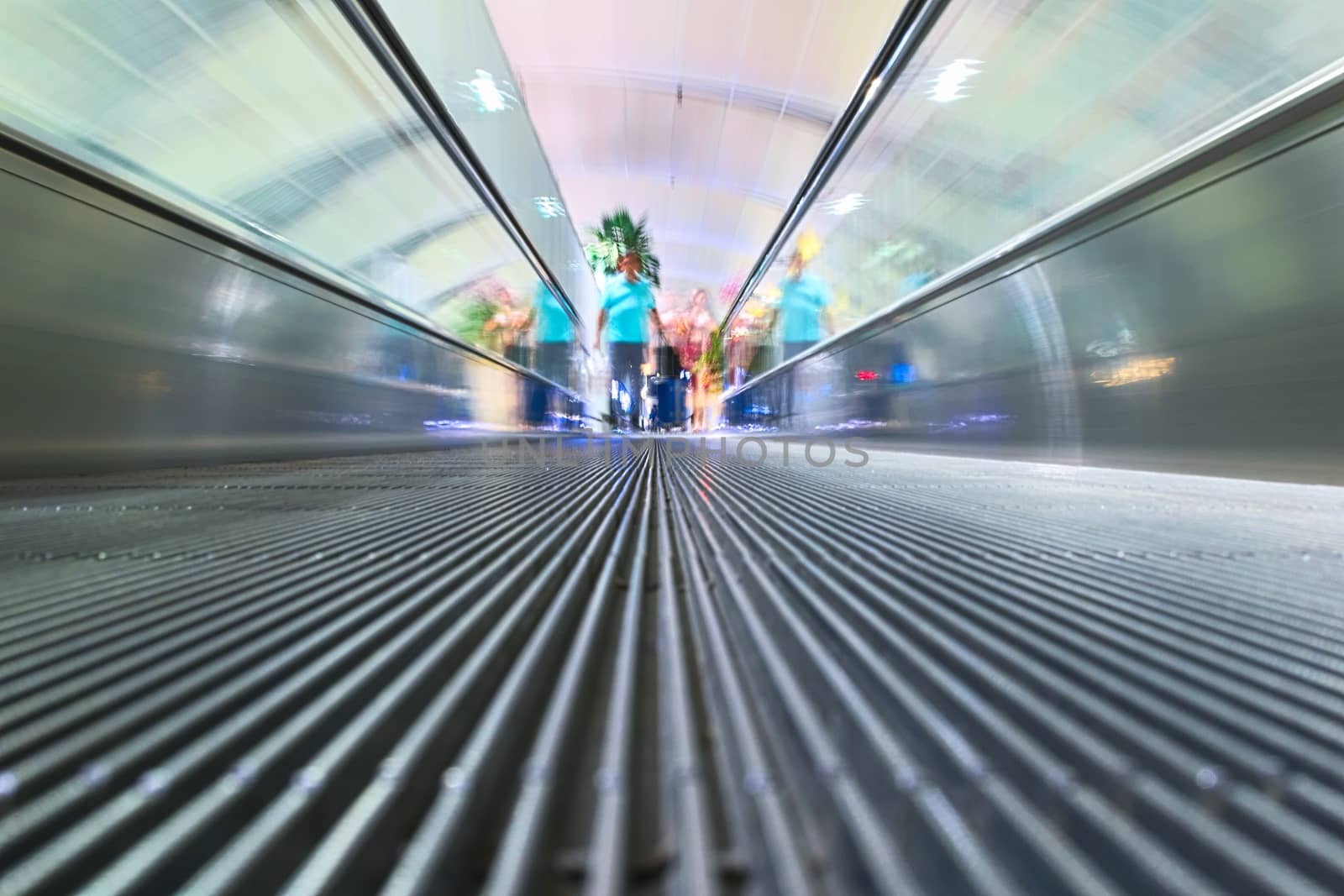 Motion blurred shot of a moving walkway at an airport. Close up. by hernan_hyper