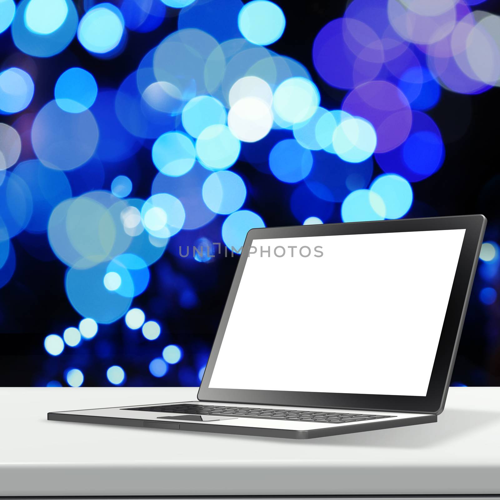 Laptop with blank screen on laminate table and blurred background