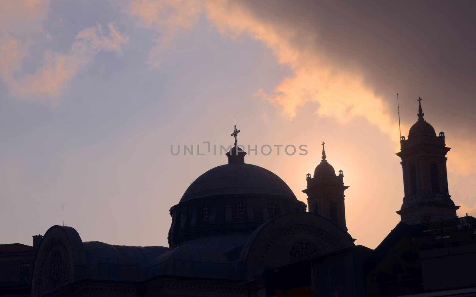 Church dome and christian crosses silhouetted against the afternoon sky in Istambul, Turkey.