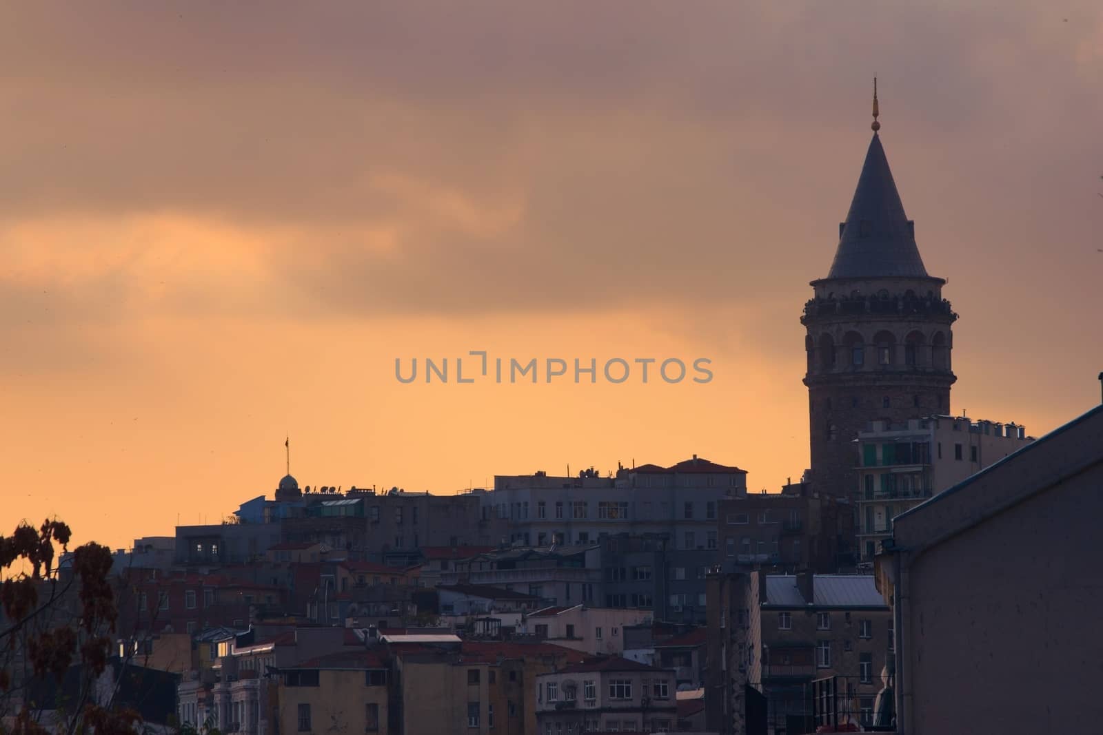 Galata Tower, in Istambul, Turkey, silhouetted against the twilight sky.