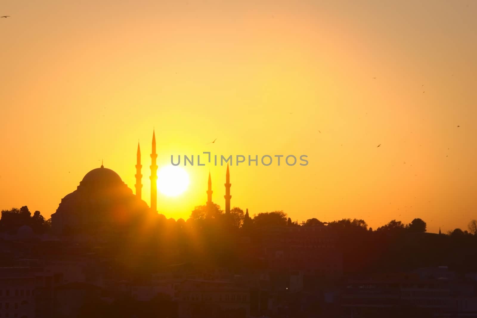 Hagia Sophia, the most important tourist attraction of Istanbul, Turkey, silhouetted against the bright sunset sky.