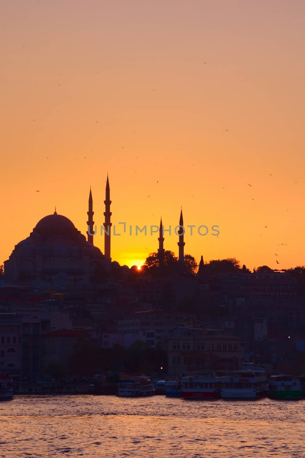 Hagia Sophia, the most important tourist attraction of Istanbul, Turkey, silhouetted against the ochre sunset sky. by hernan_hyper