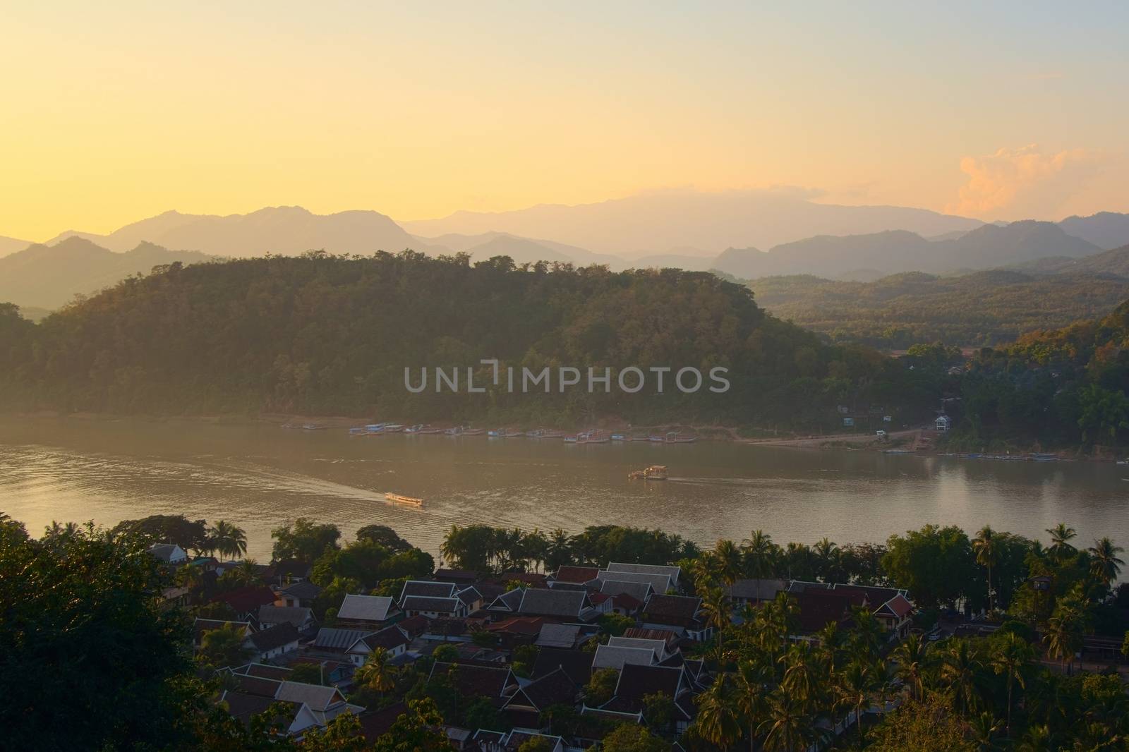 Elevated view of the city of Luang Prabang, Laos and Mekong river, in the afternoon. by hernan_hyper