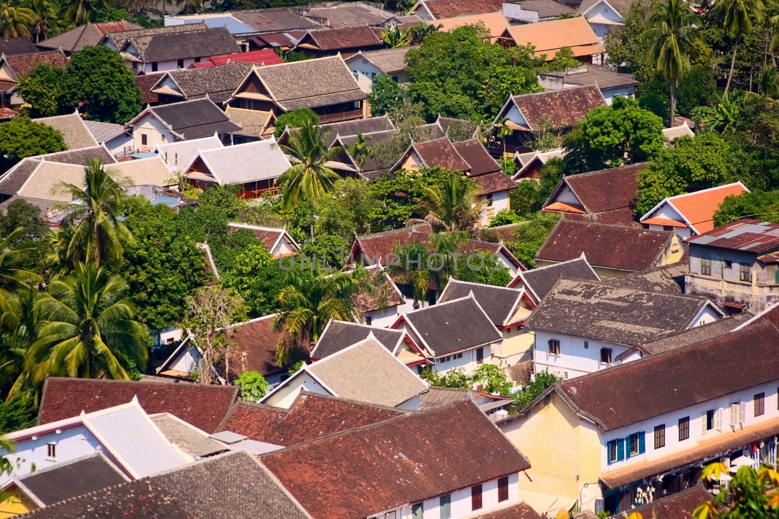 Typical east asian rooftops seen from above. Elevated view of the town of Luang Prabang, Laos, from Mt. Phou Si. by hernan_hyper