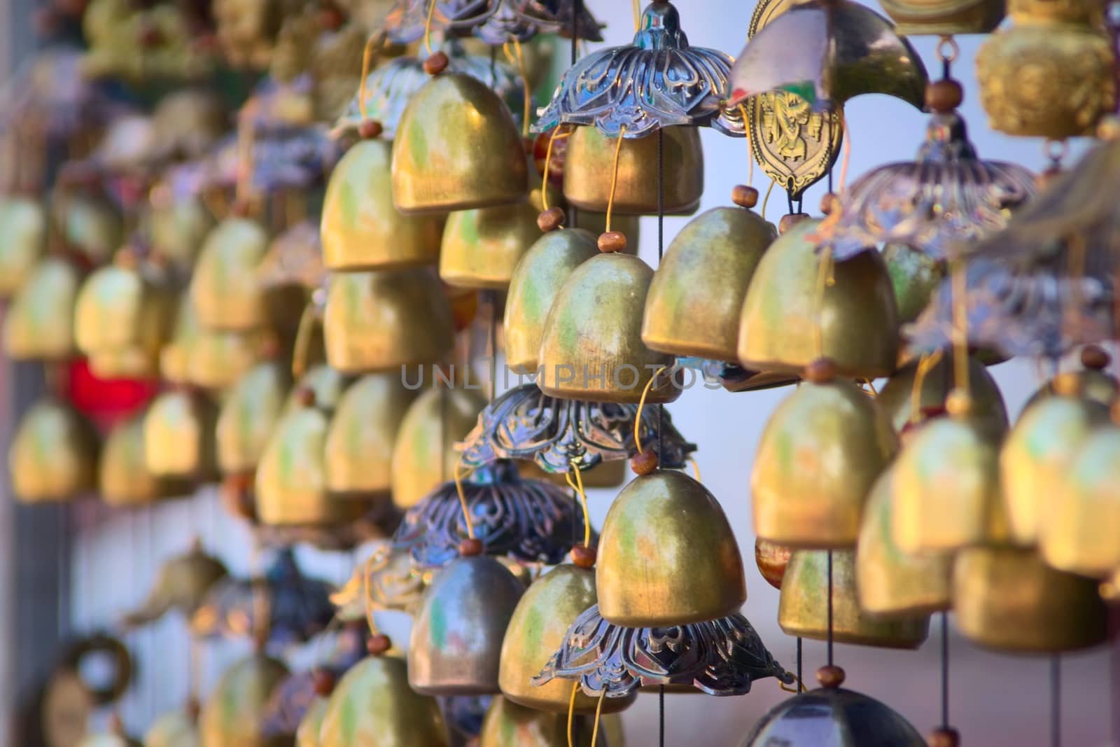 Traditional Lao chime bells at a stand in Luang Prabang, Laos. by hernan_hyper