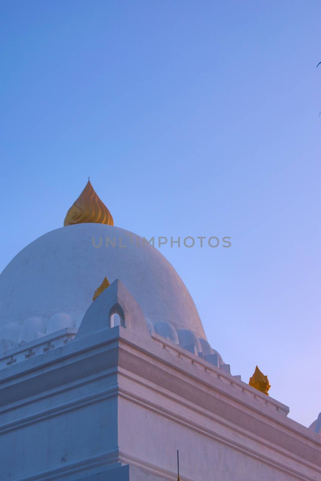 Stupa of Wat Wisunarat temple, in Luang Prabang, Laos, restored and painted white and gold in 2019. Low angle architectural detail. by hernan_hyper