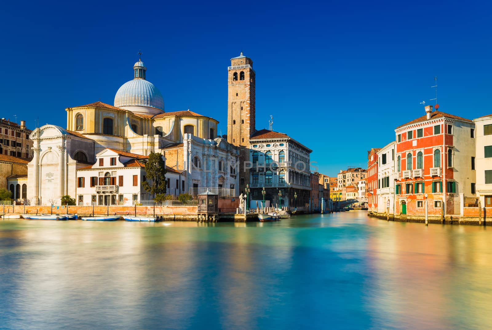 Venice, Italy. Grand Canal and Venetian old architecture against the clear blue sky on the background. Long exposure photography