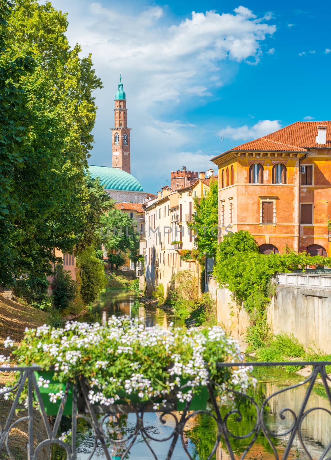 Vicenza, Italy: View of the old historical architecture, the Bacchiglione river, residential houses and fence decorated with flowers