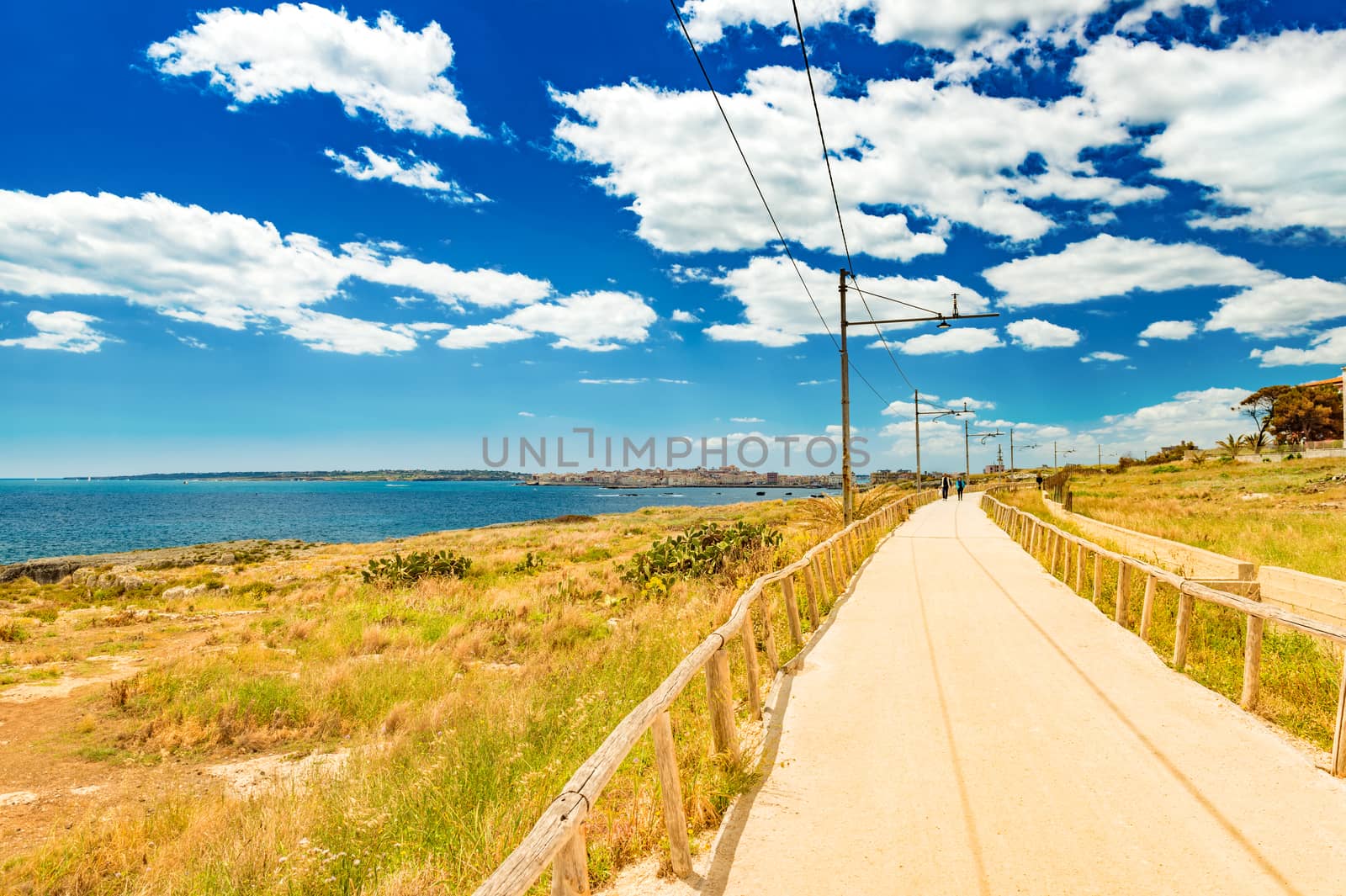Beautiful road along the coastline of Syracuse. Former railway track, Sicily, Italy