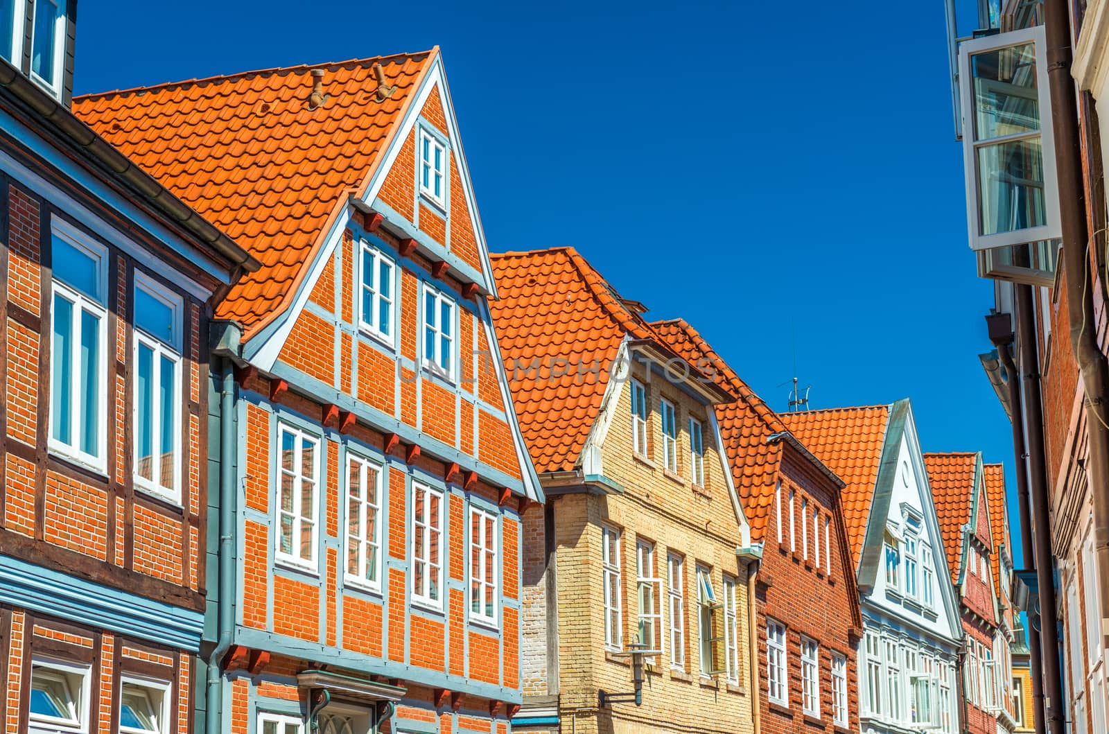 A street with traditional German architecture, half-timbered houses with red roof tiles, Stade, Germany