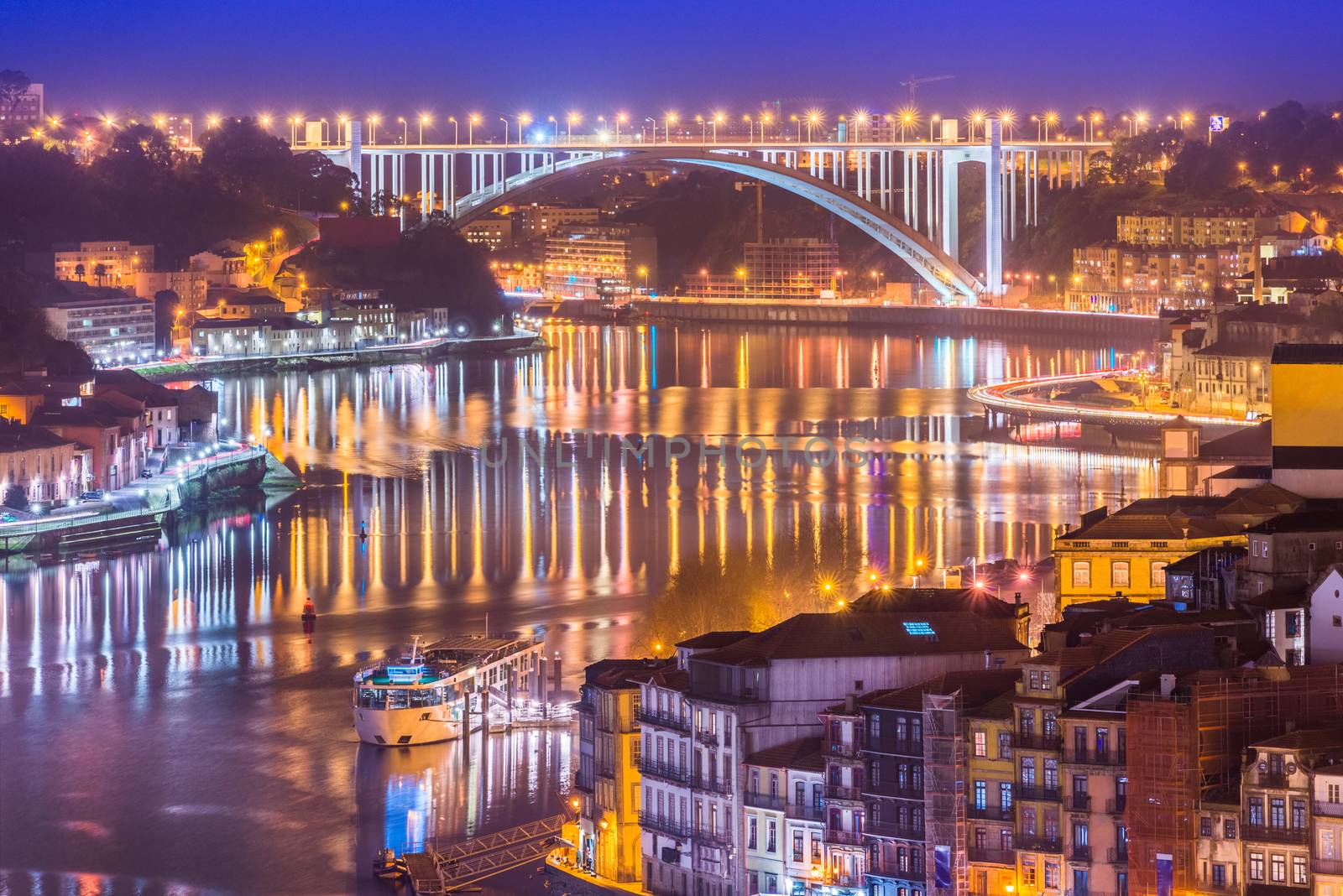 Cityscape of Porto and Arrabida Bridge (Ponte da Arrábida) at night, Valley of The Douro River, Portugal