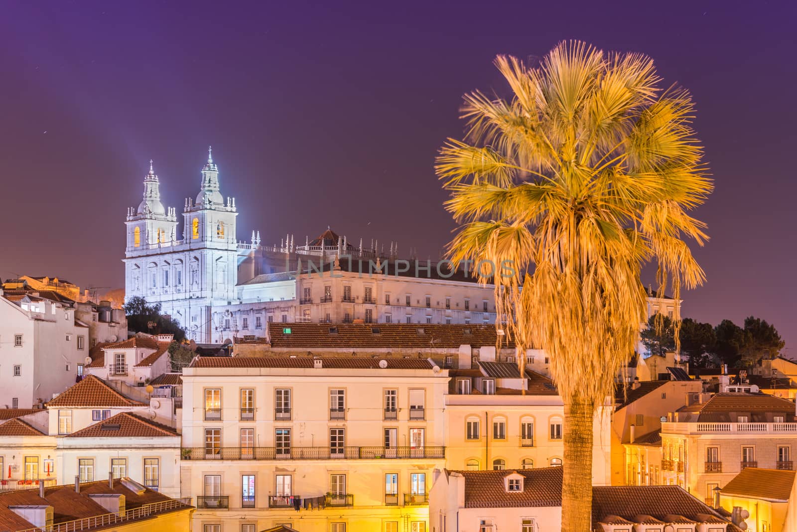 Lisbon cityscape, Alfama district at night. Facade of The Church of São Vicente of Fora (Monastery) illuminated by spotlights. Cultural Heritage of Portugal
