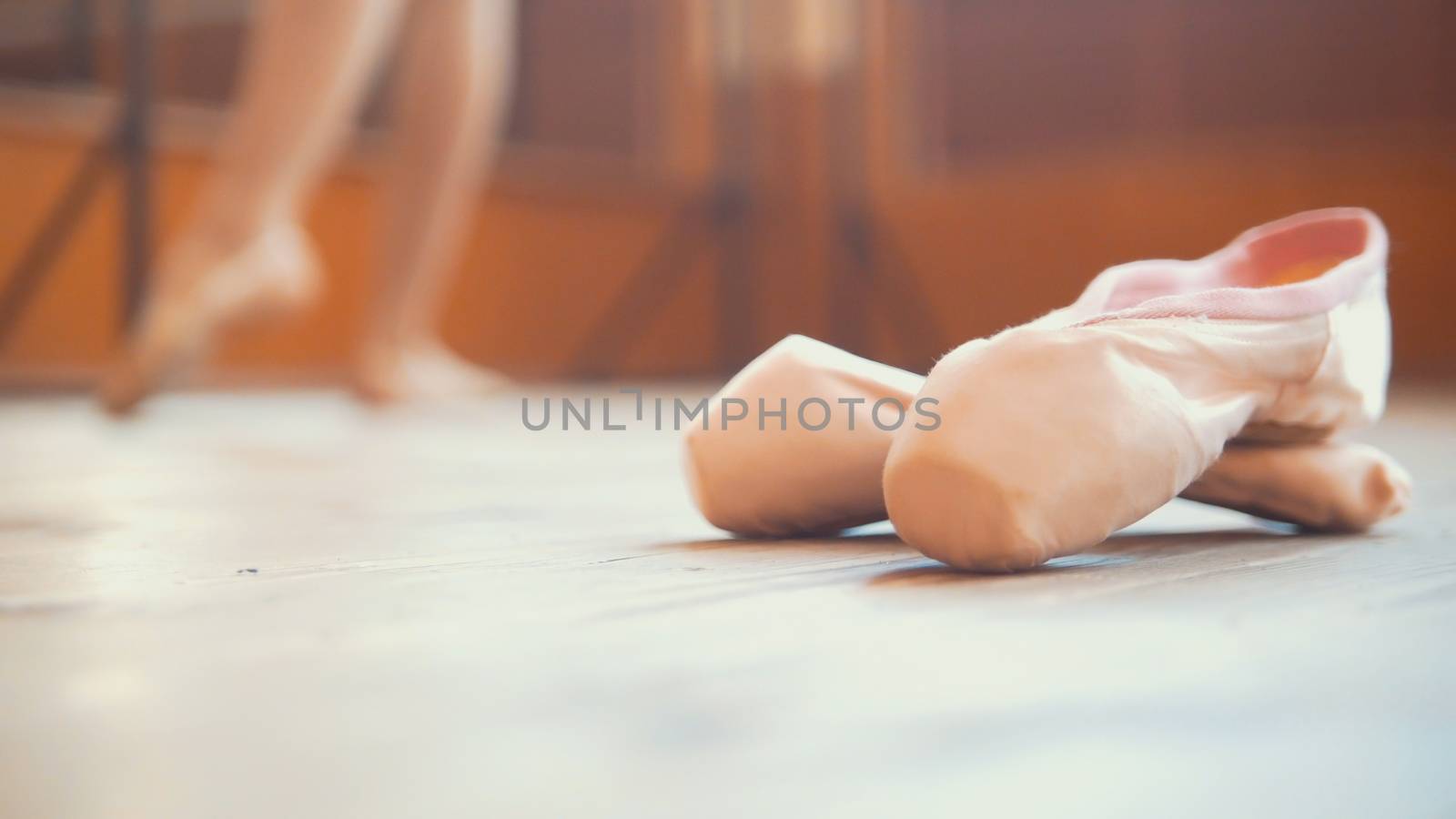 Close up of a ballet dancer's shoe in front of girl, wide angle