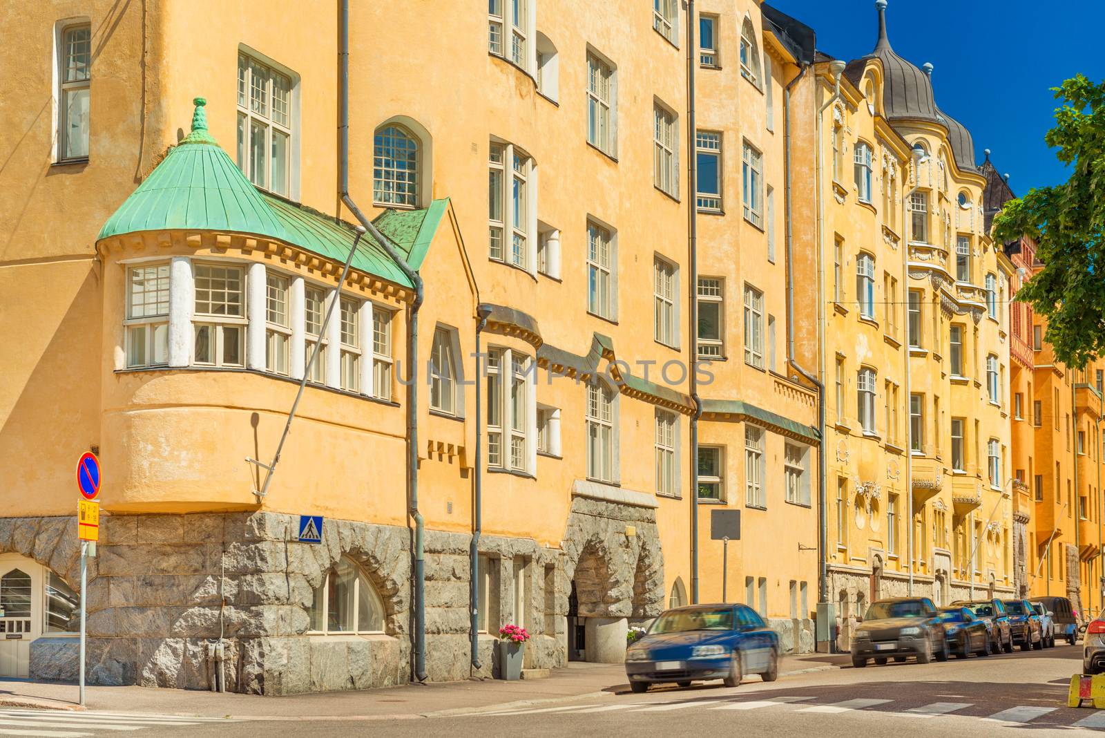 A street in Helsinki with the traditional Scandinavian architecture, bright yellow residential buildings, Finland